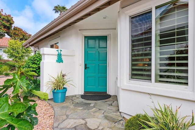 property entrance featuring stucco siding