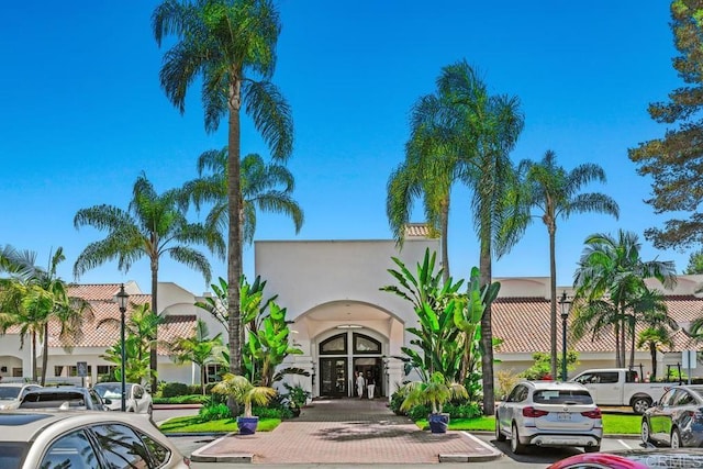 view of property featuring uncovered parking