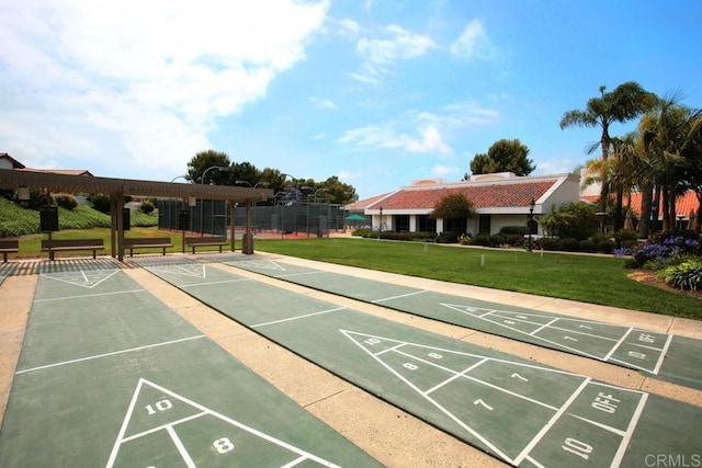 surrounding community featuring a lawn and shuffleboard