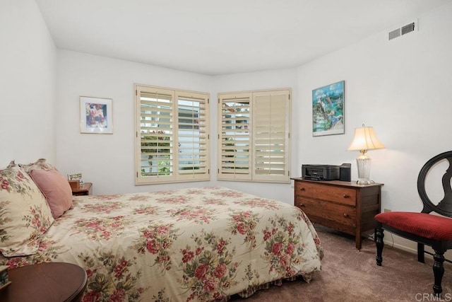 bedroom with visible vents and carpet
