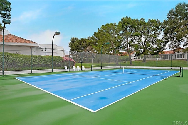 view of sport court featuring fence