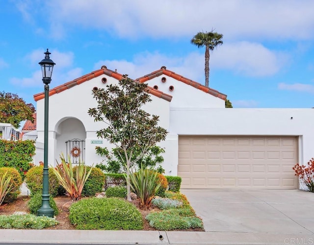 4078 Lemnos Way, Oceanside, CA 92056 - mediterranean / spanish home featuring driveway, stucco siding, and an attached garage
