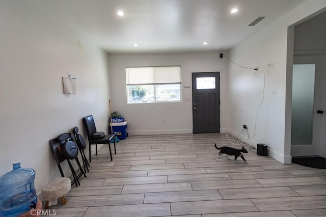 entrance foyer with baseboards, recessed lighting, light wood-style flooring, and visible vents