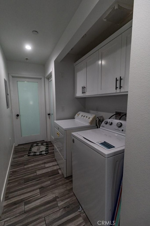 clothes washing area featuring baseboards, dark wood-style flooring, cabinet space, and washer and dryer