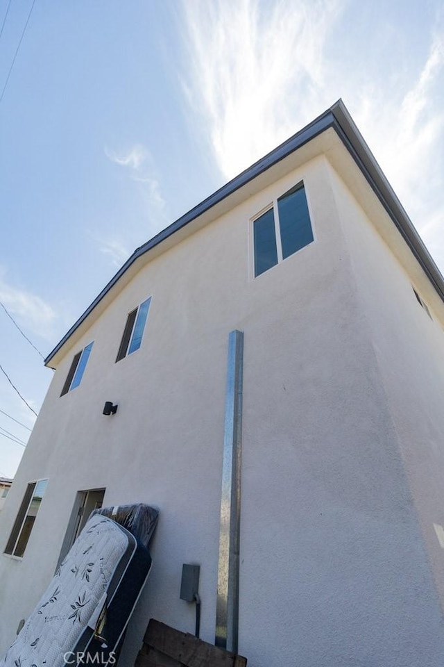 view of side of property featuring stucco siding