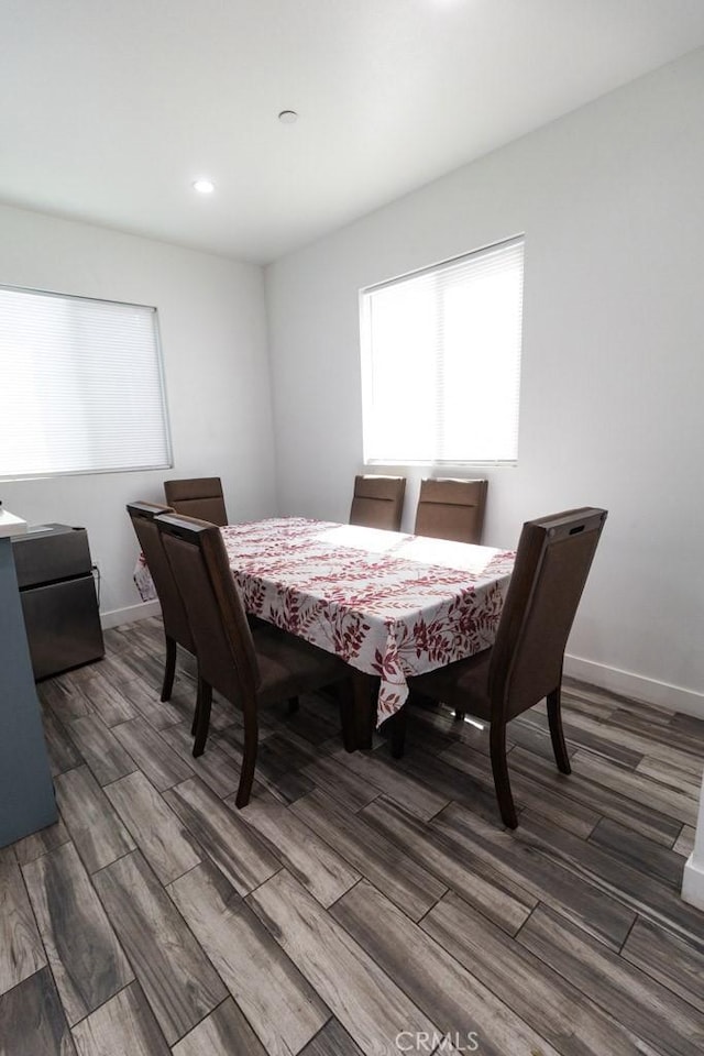 dining room with baseboards, recessed lighting, and wood finished floors
