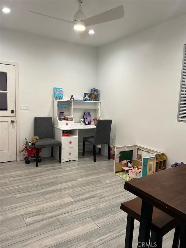 office featuring recessed lighting, a ceiling fan, and light wood-style flooring