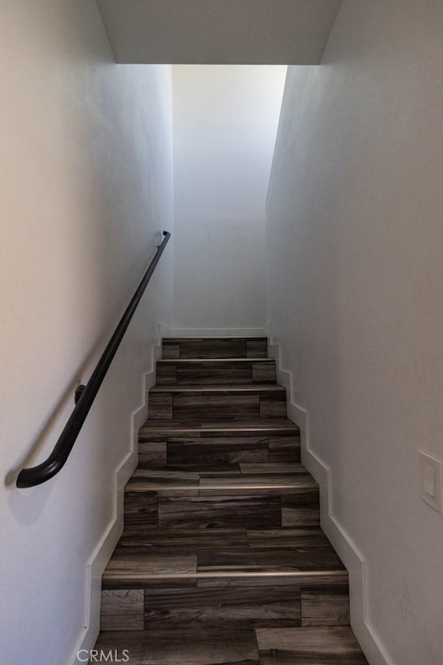stairway with wood finished floors