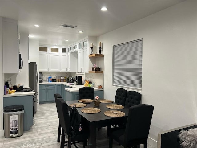 dining room featuring visible vents, recessed lighting, and light wood-type flooring