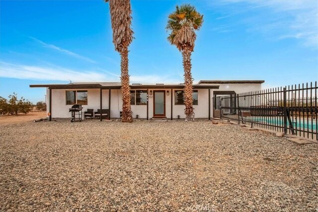 3737 Meriwether Rd Unit 29, Palms, CA 92277 - rear view of property featuring fence and stucco siding