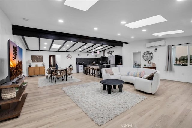 3737 Meriwether Rd Unit 29, Palms, CA 92277 - living room featuring a skylight, a wall unit AC, light wood-style flooring, and beam ceiling