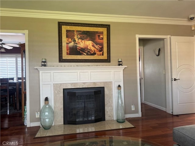 details with crown molding, baseboards, a tiled fireplace, and wood finished floors