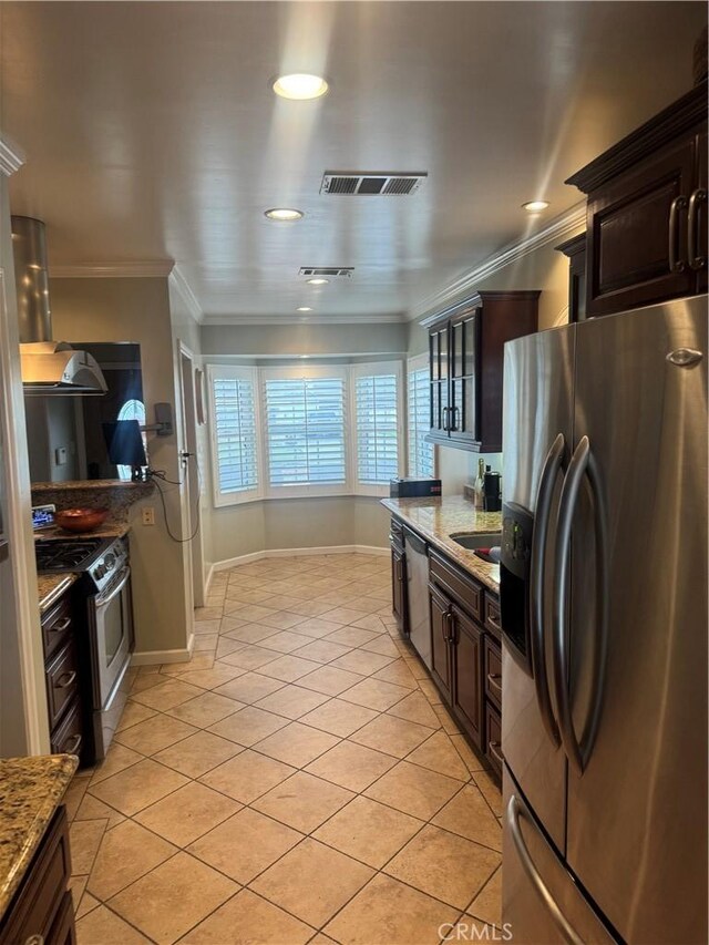 kitchen featuring crown molding, light stone countertops, stainless steel appliances, and light tile patterned flooring