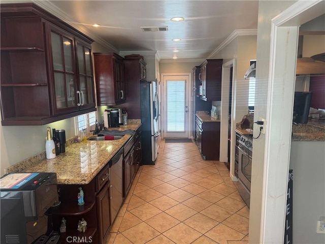kitchen featuring a sink, open shelves, appliances with stainless steel finishes, and a healthy amount of sunlight