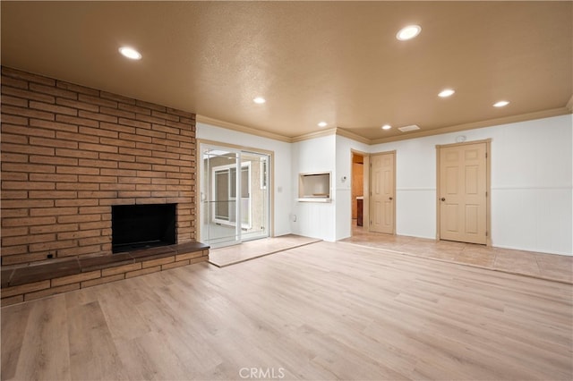 5449 E Fairbrook St, Long Beach, CA 90815 - unfurnished living room featuring crown molding, recessed lighting, light wood-style flooring, and a fireplace