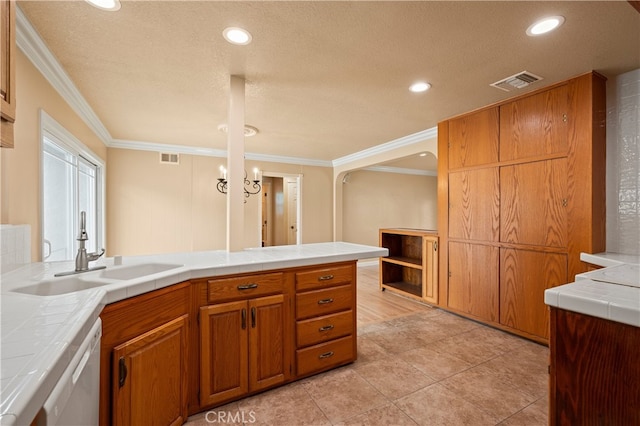 5449 E Fairbrook St, Long Beach, CA 90815 - kitchen featuring a sink, tile counters, brown cabinetry, visible vents, and ornamental molding