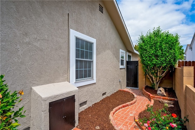 5449 E Fairbrook St, Long Beach, CA 90815 - view of home's exterior with stucco siding, crawl space, and fence
