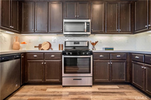 kitchen with light countertops, stainless steel appliances, and dark brown cabinets