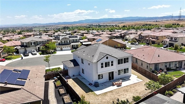 drone / aerial view featuring a residential view and a mountain view