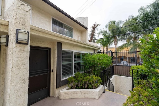 entrance to property with stucco siding