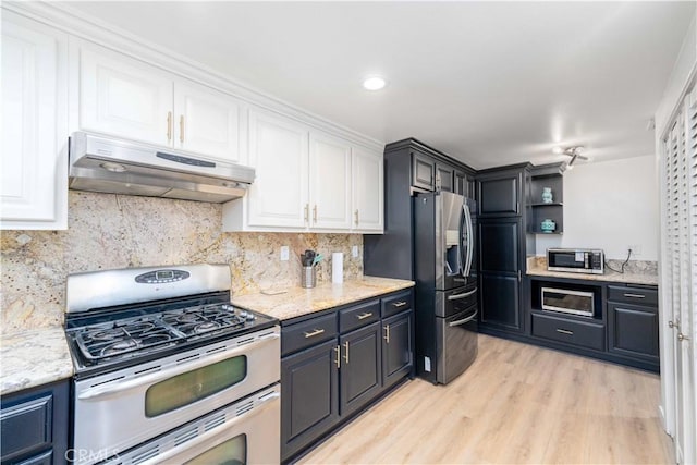 kitchen featuring open shelves, under cabinet range hood, white cabinets, light wood-style flooring, and appliances with stainless steel finishes