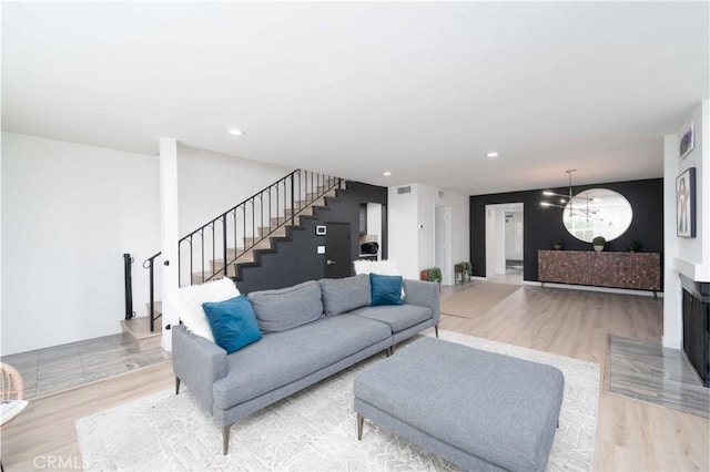 living room with visible vents, stairway, a chandelier, light wood-style floors, and recessed lighting