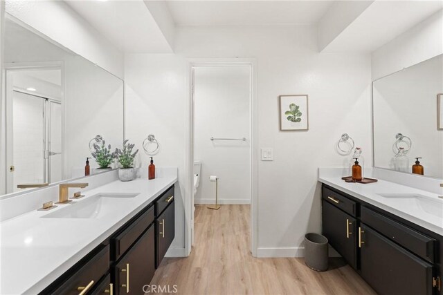 4321 Matilija Ave Unit 9, Sherman Oaks, CA 91423 - full bathroom with wood finished floors, two vanities, and a shower with door