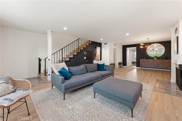 4321 Matilija Ave Unit 9, Sherman Oaks, CA 91423 - living room with stairway, light wood-type flooring, and a chandelier