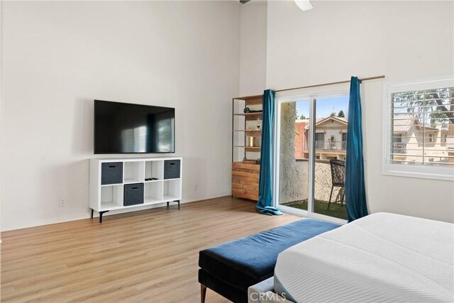 4321 Matilija Ave Unit 9, Sherman Oaks, CA 91423 - bedroom featuring access to exterior, wood finished floors, a towering ceiling, and ceiling fan