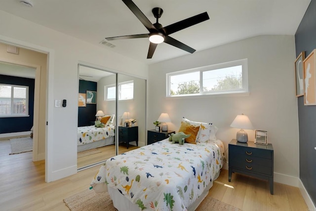 bedroom with a ceiling fan, visible vents, baseboards, a closet, and light wood finished floors