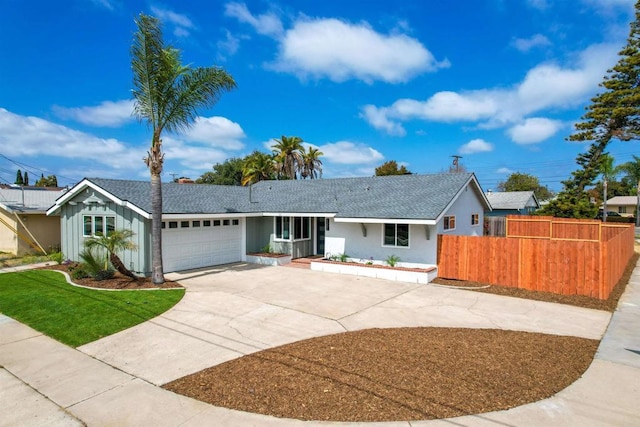 ranch-style house with fence, a shingled roof, an attached garage, and driveway