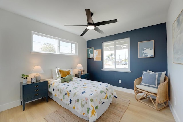 bedroom featuring light wood-style floors and baseboards