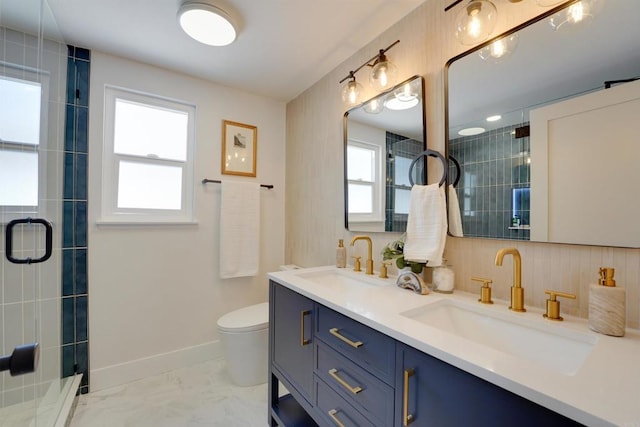 full bathroom featuring double vanity, a sink, baseboards, and tiled shower