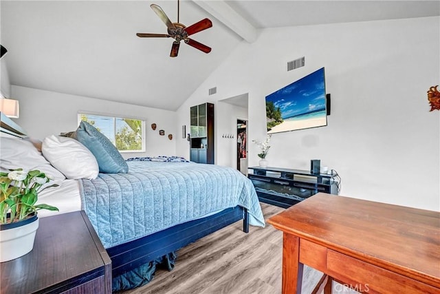 bedroom featuring ceiling fan, beam ceiling, visible vents, and wood finished floors