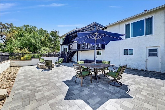 view of patio / terrace with stairs, outdoor dining area, a fenced backyard, and a wooden deck