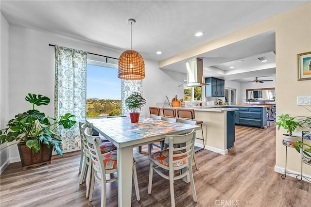 dining area featuring recessed lighting, baseboards, a healthy amount of sunlight, and light wood-style floors