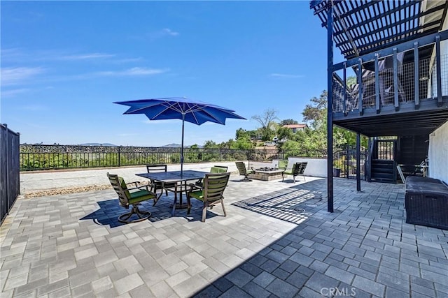 view of patio featuring a pergola, a fire pit, a fenced backyard, and outdoor dining space