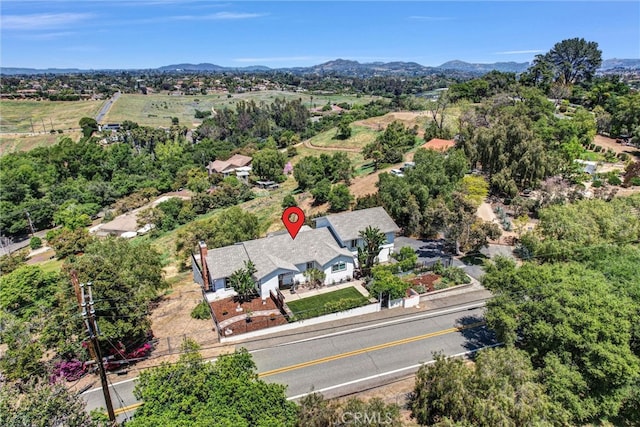 birds eye view of property featuring a mountain view