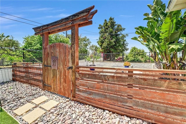 view of gate featuring fence