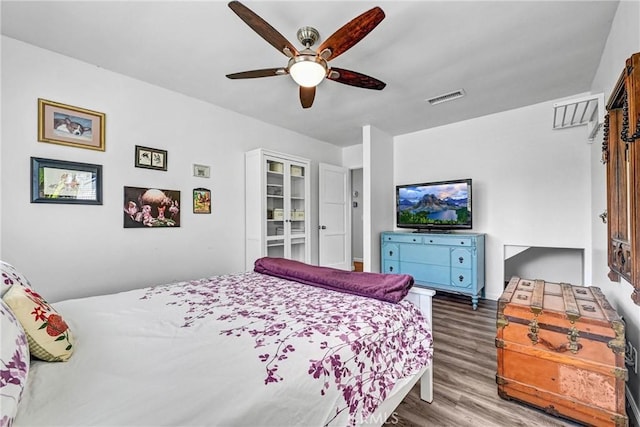 bedroom featuring visible vents, ceiling fan, and wood finished floors