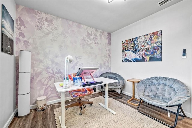 office with baseboards, wallpapered walls, visible vents, and wood finished floors