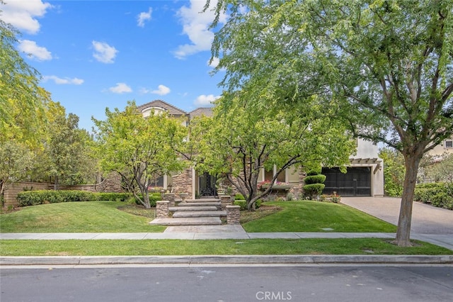 obstructed view of property featuring an attached garage, a front lawn, stucco siding, and driveway