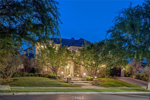 obstructed view of property featuring a front lawn