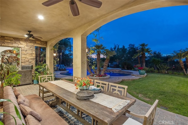 patio at twilight with an outdoor pool, a fenced backyard, outdoor dining area, a ceiling fan, and a yard