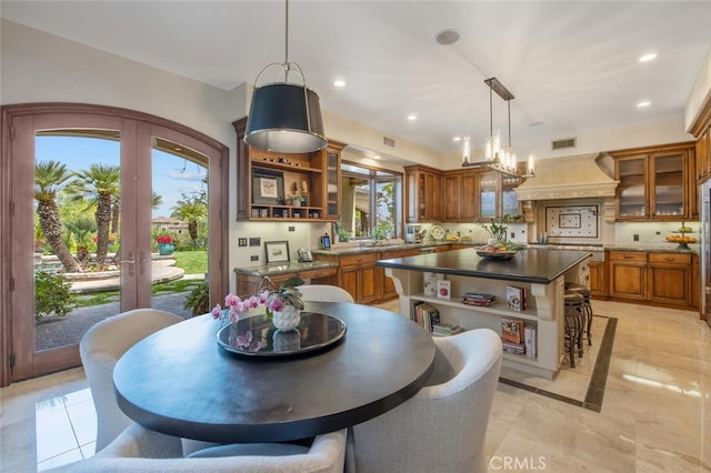 dining space with a wealth of natural light, french doors, recessed lighting, and visible vents