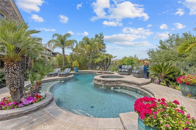 view of pool with a fenced in pool, fence, a patio, and an in ground hot tub