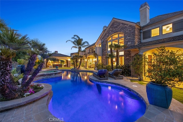 view of swimming pool featuring a patio and a pool with connected hot tub
