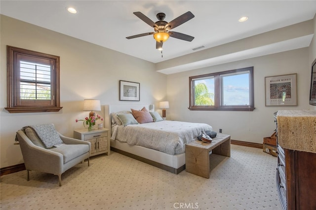 bedroom with baseboards, multiple windows, recessed lighting, and visible vents