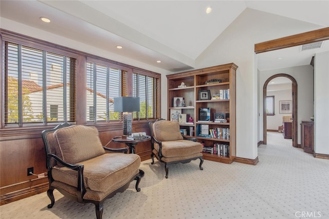 sitting room featuring arched walkways, vaulted ceiling, baseboards, light carpet, and recessed lighting