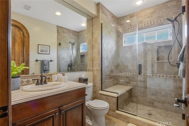 full bath featuring toilet, visible vents, and a shower stall